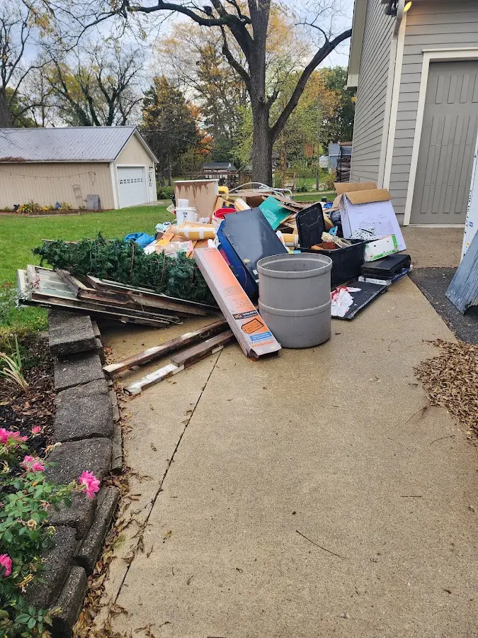 Dumpster being loaded with debris for 10 Yard Dumpster Rental in Greenfield